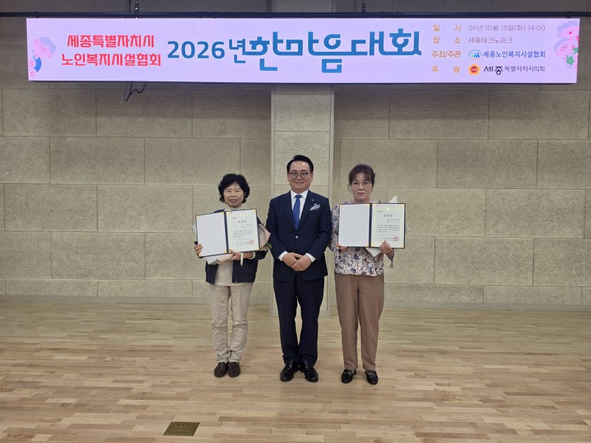 한철수 한국노인복지중앙회장이 상장을 든 여성 종사자 두 명 사이에 서서 기념사진을 찍고 있다